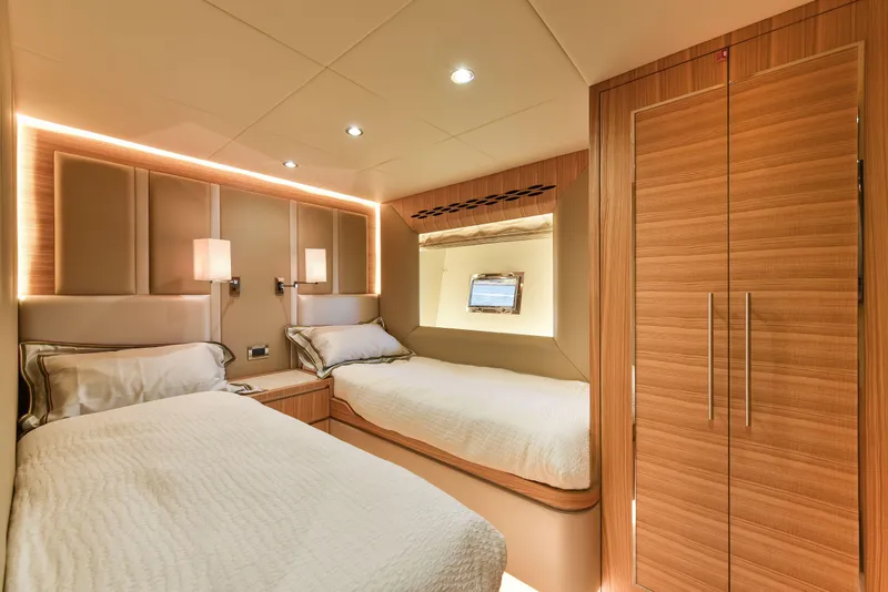 Slide: The Image of Luxurious twin cabin interior of 2025 Nomad 65 yacht with modern wood finishes. - 7