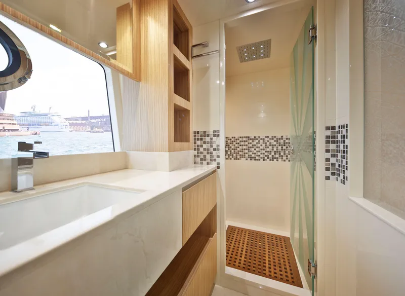 Slide: The Image of Luxurious bathroom in 2025 Nomad 65 yacht with modern shower and elegant wood accents. - 8