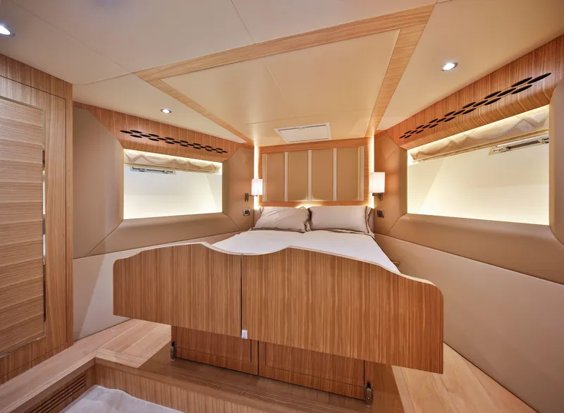 Slide: The Image of Luxurious bedroom interior of 2025 Nomad 65 yacht with modern wood finishes. - 9