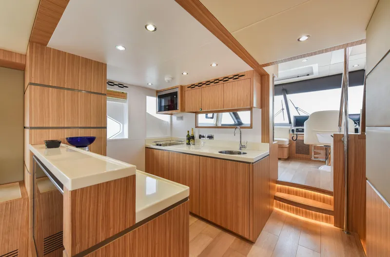 Slide: The Image of Luxurious Nomad 65 yacht interior with modern kitchen and helm, 2025 model. - 4