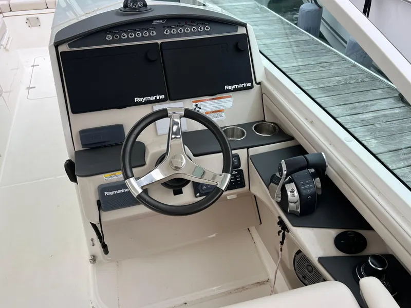 Slide: The Image of 2018 Boston Whaler 320 Vantage helm with Raymarine electronics and steering wheel. - 4