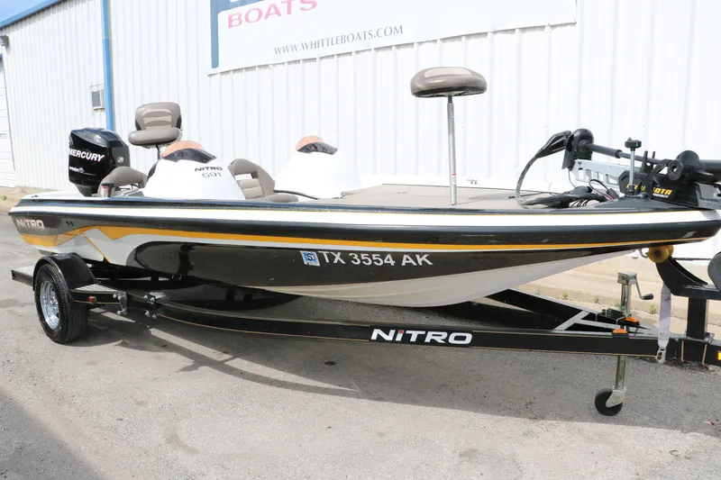 Slide: The Image of 2007 Nitro NX 591 DC fishing boat with Mercury engine, parked outside a dealership. - 12