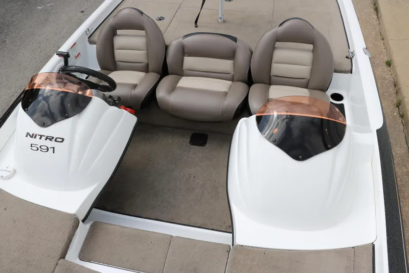 Slide: The Image of 2007 Nitro NX 591 DC boat interior with beige seats and dual consoles. - 19