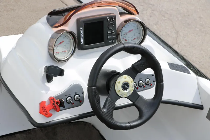 Slide: The Image of 2007 Nitro NX 591 DC boat dashboard with steering wheel and Lowrance fish finder. - 22