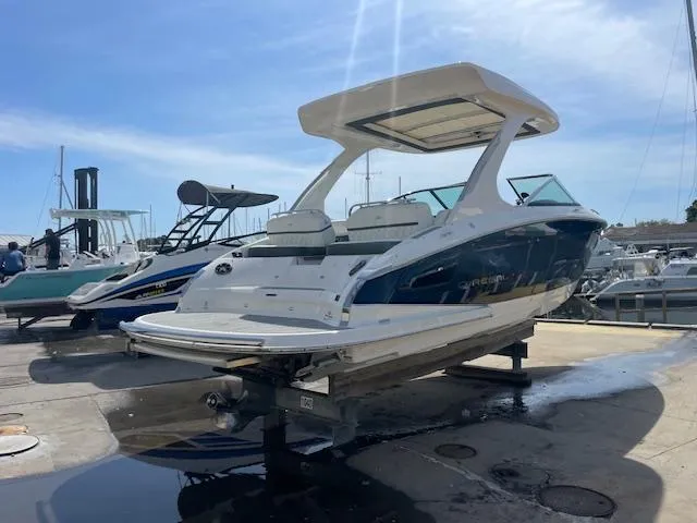 Slide: The Image of 2020 Regal 2800 boat on a dock under a clear blue sky. - 0