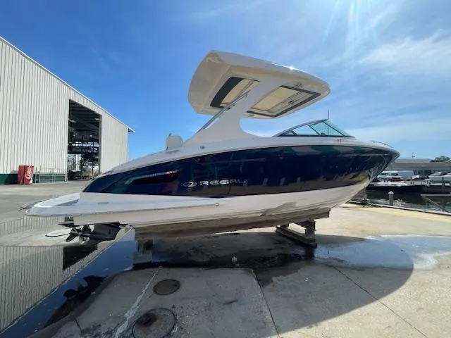 Slide: The Image of 2020 Regal 2800 boat on a dock under a clear blue sky. - 1