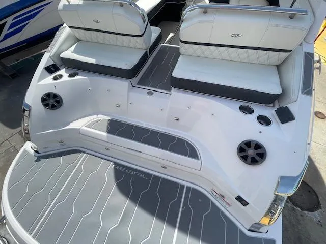 Slide: The Image of 2020 Regal 2800 boat with white seating and gray deck. - 11
