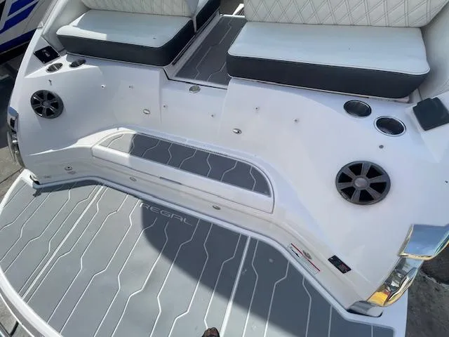 Slide: The Image of 2020 Regal 2800 boat stern with seating, speakers, and cup holders. - 13