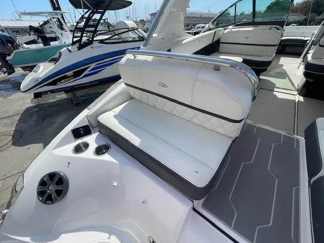 Slide: The Image of 2020 Regal 2800 boat interior with white seating and cup holders. - 14
