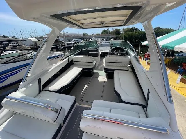 Slide: The Image of 2020 Regal 2800 boat with spacious seating and modern design at a marina. - 17