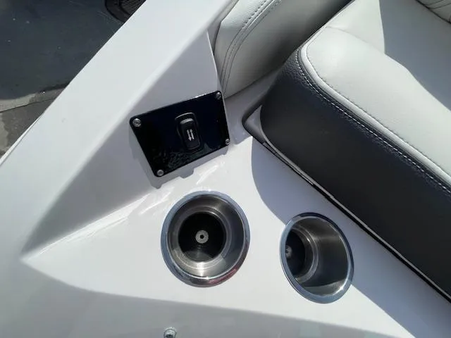 Slide: The Image of Regal 2800 boat interior, 2020 model, featuring cup holders and a control switch. - 18