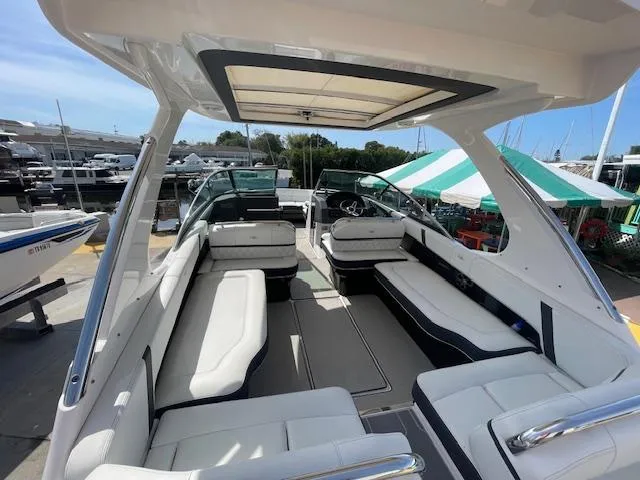 Slide: The Image of 2020 Regal 2800 boat interior with white seating and open canopy. - 19