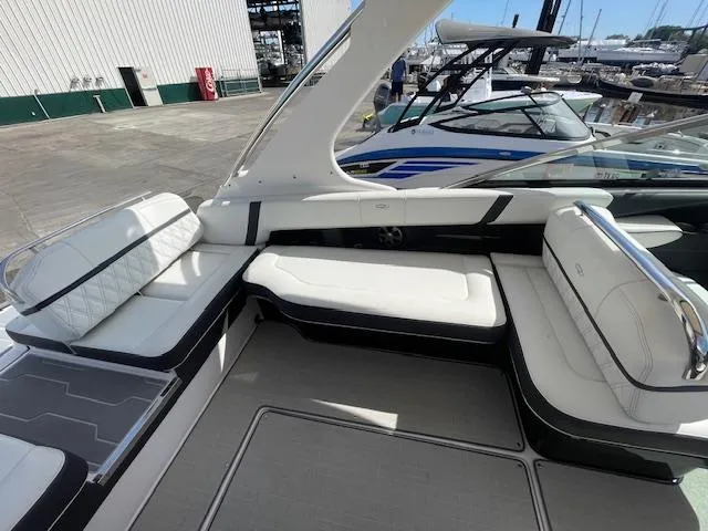 Slide: The Image of 2020 Regal 2800 boat interior with white leather seating at marina. - 20