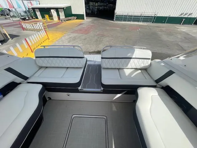 Slide: The Image of 2020 Regal 2800 boat interior with white and black seating, docked at a marina. - 21