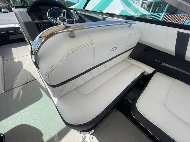 Slide: The Image of Interior of a 2020 Regal 2800 boat with white leather seating and steering wheel. - 23