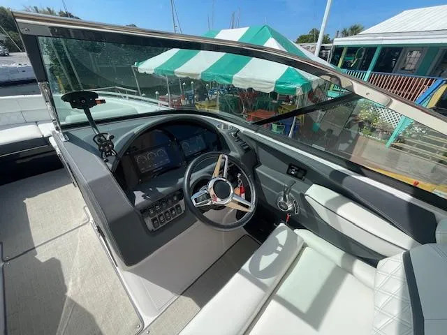 Slide: The Image of 2020 Regal 2800 boat cockpit with steering wheel and dashboard. - 27