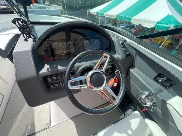 Slide: The Image of 2020 Regal 2800 boat dashboard with steering wheel and digital display. - 28