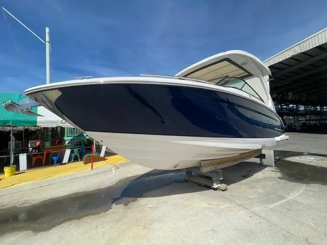 Slide: The Image of 2020 Regal 2800 boat on dry dock under clear blue sky. - 3