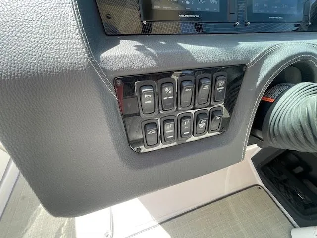 Slide: The Image of Control panel of a 2020 Regal 2800 boat with various switches. - 31