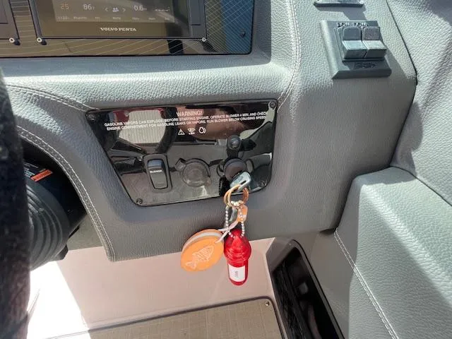 Slide: The Image of Control panel of a 2020 Regal 2800 boat with ignition keys and safety lanyard. - 32