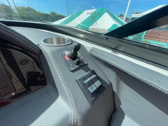 Slide: The Image of Control panel of a 2020 Regal 2800 boat with joystick and switches. - 33