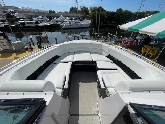 Slide: The Image of 2020 Regal 2800 boat with spacious seating at a marina. - 35