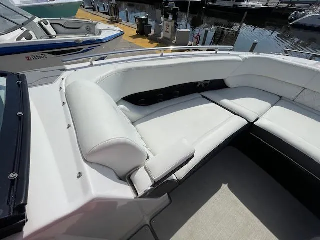 Slide: The Image of Regal 2800 2020 boat with white leather seating at a marina. - 36