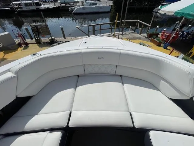 Slide: The Image of 2020 Regal 2800 boat with white cushioned seating at dock. - 38