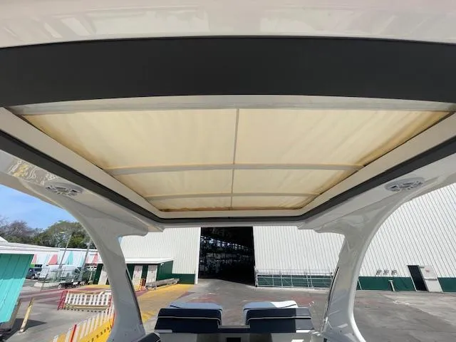 Slide: The Image of 2020 Regal 2800 boat with retractable sunroof at a marina. - 40