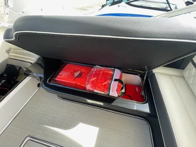 Slide: The Image of Storage compartment in a 2020 Regal 2800 boat with life jackets. - 42