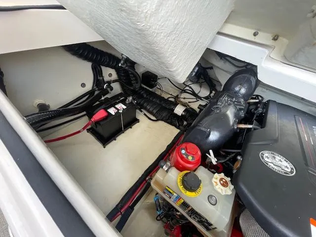 Slide: The Image of Engine compartment of a 2020 Regal 2800 boat showing battery and engine components. - 45