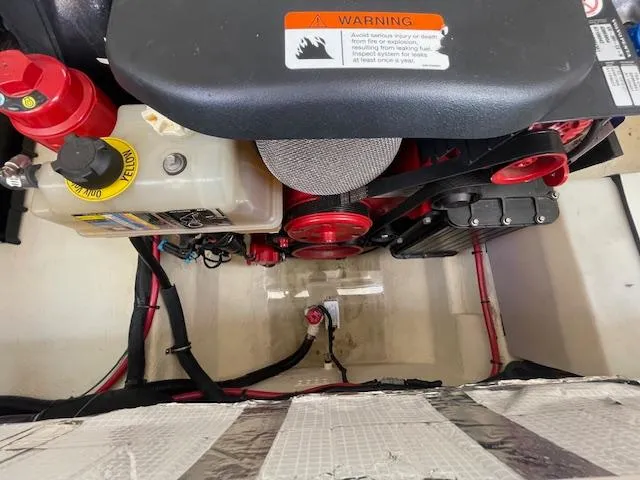 Slide: The Image of Engine compartment of a 2020 Regal 2800 boat with visible components and warning label. - 46