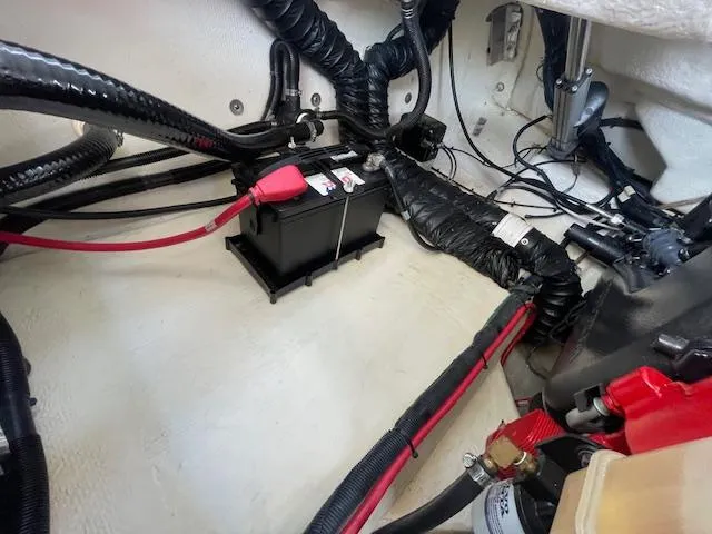 Slide: The Image of Battery compartment of a 2020 Regal 2800 boat with wiring and cables. - 47
