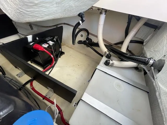 Slide: The Image of Engine compartment of a 2020 Regal 2800 boat showing battery and hoses. - 48