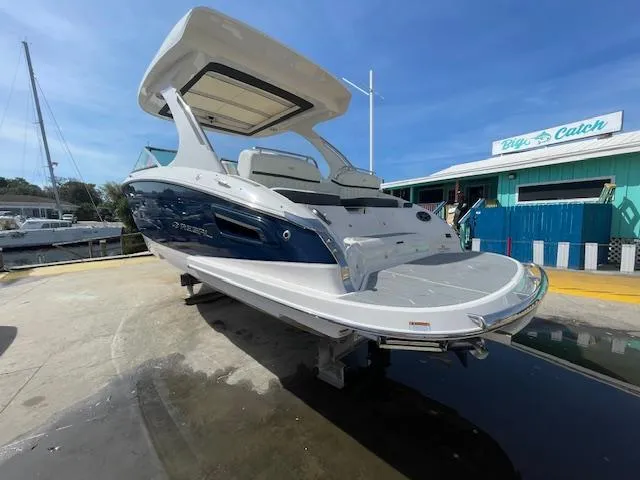 Slide: The Image of 2020 Regal 2800 boat docked at marina with blue and white exterior. - 5