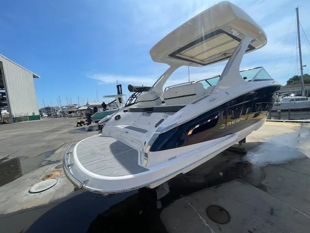 Slide: The Image of 2020 Regal 2800 boat docked at a marina, rear view. - 8