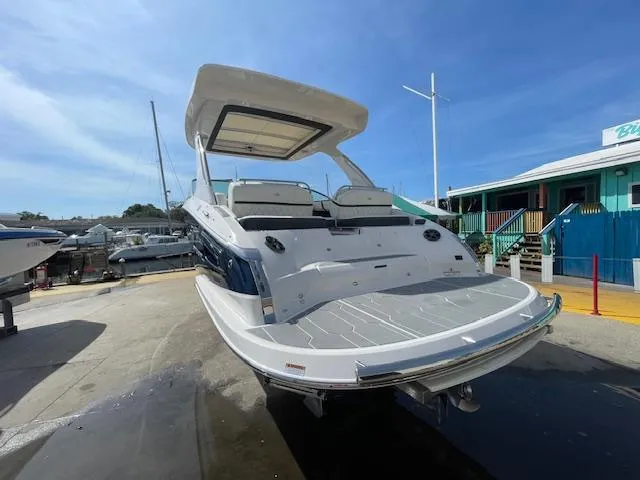 Slide: The Image of 2020 Regal 2800 boat docked at a marina under a clear blue sky. - 9