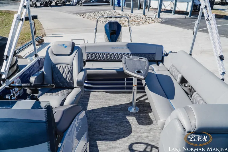 Slide: The Image of 2023 Bennington 24LXSB pontoon boat interior with luxurious seating and table at Lake Norman Marina. - 14