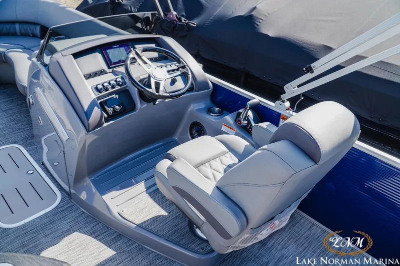 Slide: The Image of 2023 Bennington 24LXSB boat cockpit with captain's chair and control panel at Lake Norman Marina. - 8