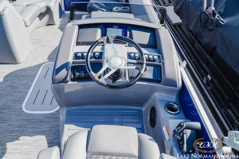 Slide: The Image of 2023 Bennington 24LXSB boat helm with modern controls and steering wheel. - 9