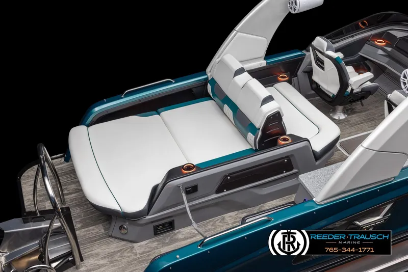 Slide: The Image of 2024 Avalon Excalibur VRB luxury boat interior with white and teal seating. - 3