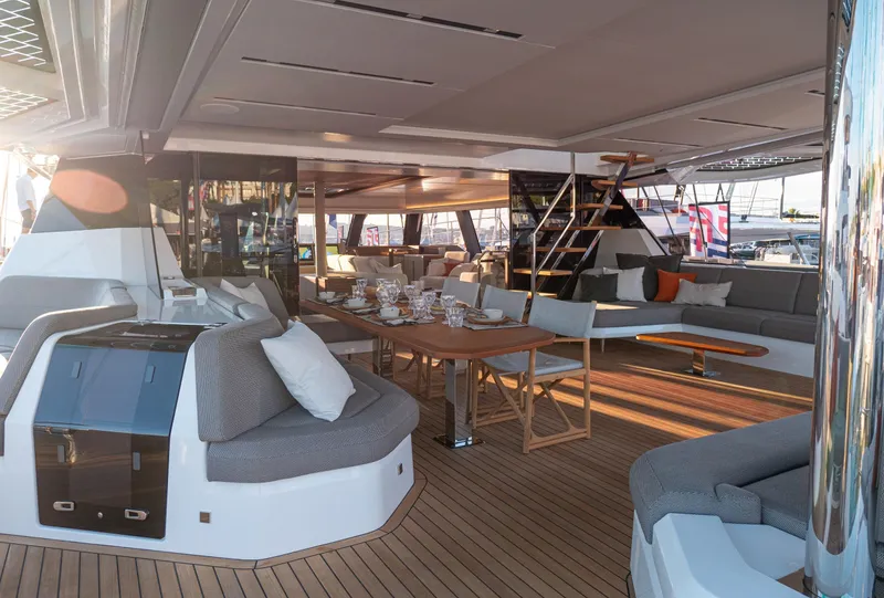 Slide: The Image of Luxurious 2025 Fountaine Pajot Thira 80 yacht interior with elegant seating and dining area. - 12