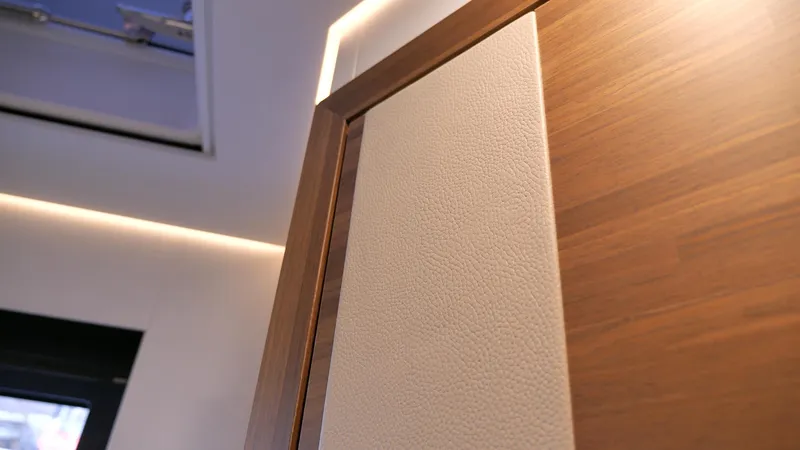 Slide: The Image of Interior detail of 2025 Fountaine Pajot Thira 80, featuring wood and textured paneling. - 22