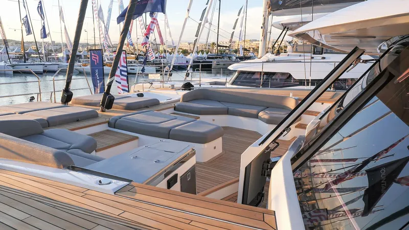 Slide: The Image of Luxurious 2025 Fountaine Pajot Thira 80 yacht with spacious deck and modern seating at marina. - 5