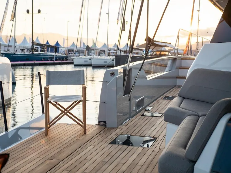 Slide: The Image of Luxury deck of 2025 Fountaine Pajot Thira 80 yacht at sunset in marina. - 8