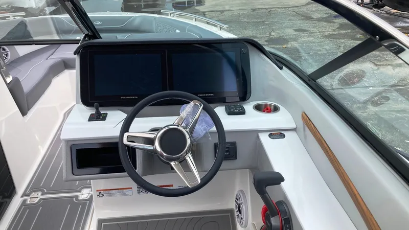 Slide: The Image of 2024 Regal LS9 boat dashboard with dual screens and modern steering wheel. - 17