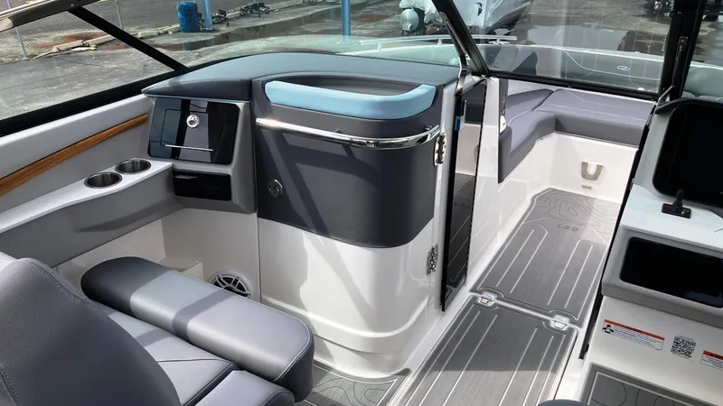 Slide: The Image of 2024 Regal LS9 boat interior with modern seating and sleek dashboard design. - 18