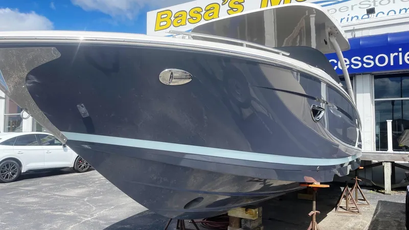 Slide: The Image of 2024 Regal LS9 boat displayed outdoors at a dealership. - 2