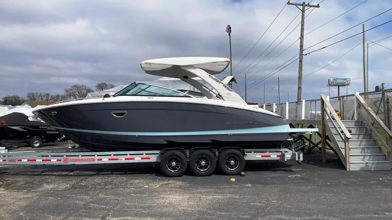 Slide: The Image of 2024 Regal LS9 boat on a trailer in a parking lot. - 5