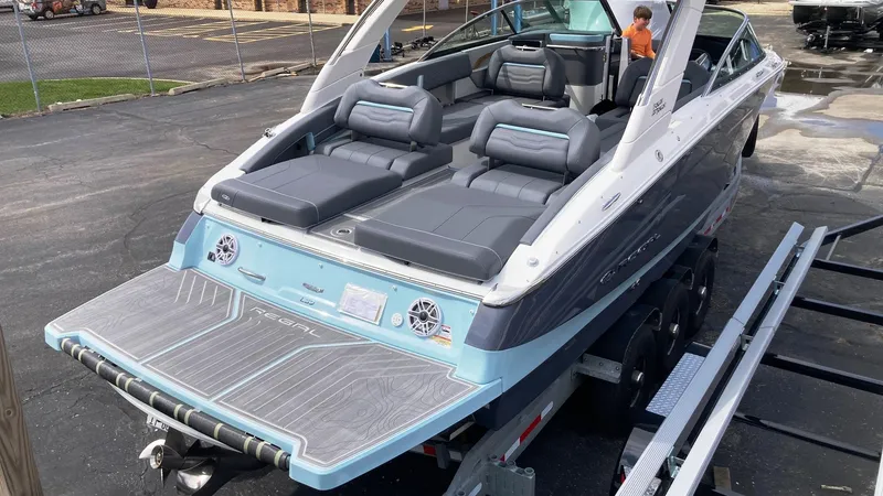 Slide: The Image of 2024 Regal LS9 boat with luxurious seating and modern design on a trailer. - 9